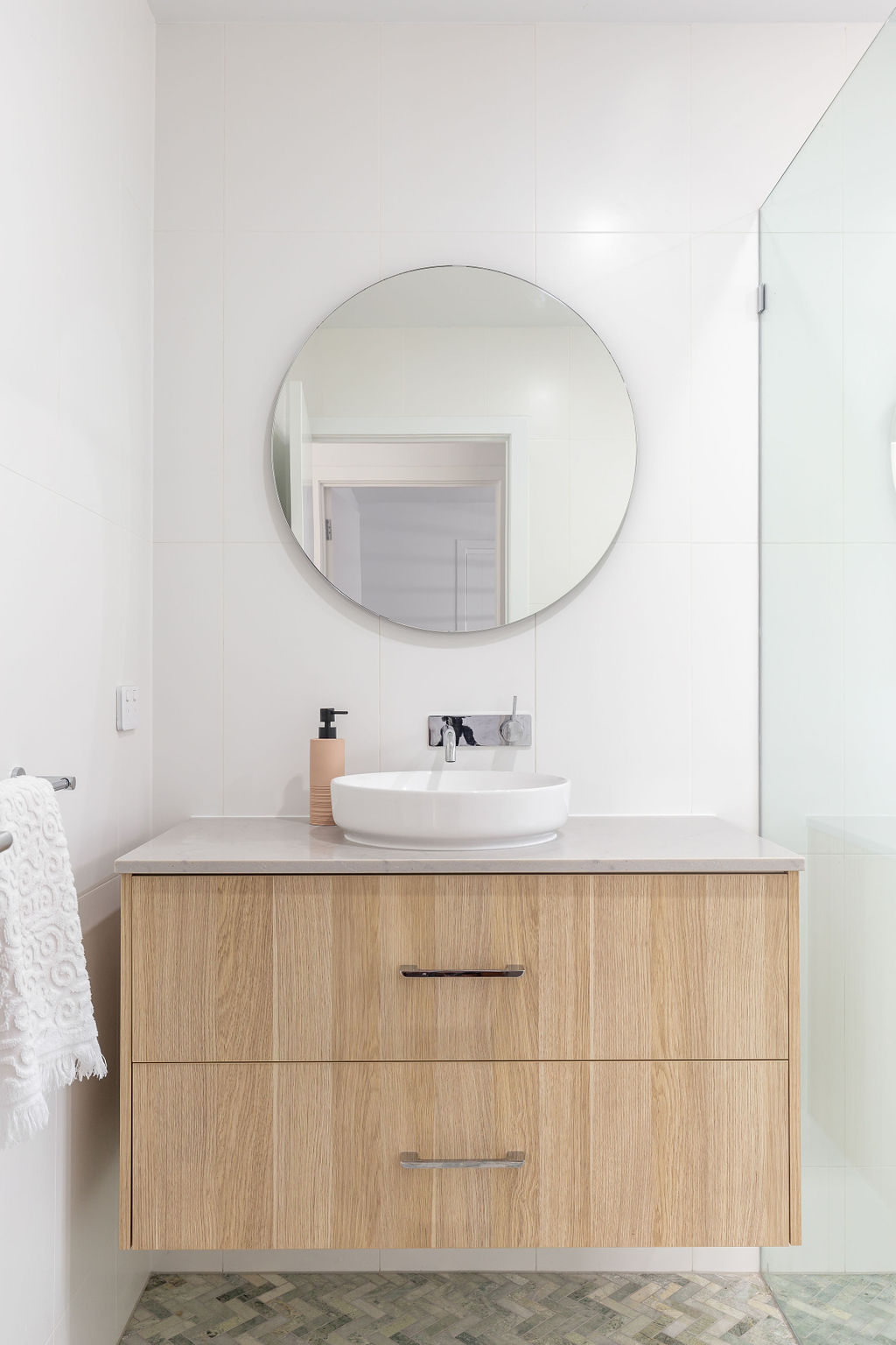 floating vanity installation - bathroom renovator gold coast - best bathroom renovations on the gold coast - amazing bathroom designs - herringbone tiles